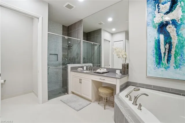 a bathroom with a tub sink and mirror