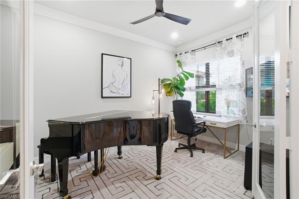 4318 Aurora Street Naples, FL 34119 - Photo 27 of 50 Elegant den with crown molding and expansive windows that fill the space with natural light—perfect for a home office, studio, or flex space.