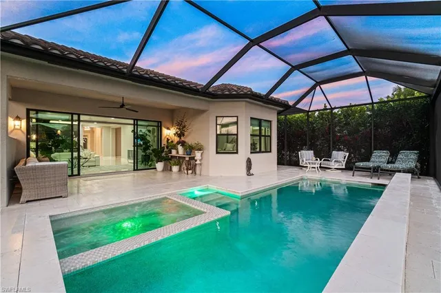 a view of a backyard with swimming pool and furniture