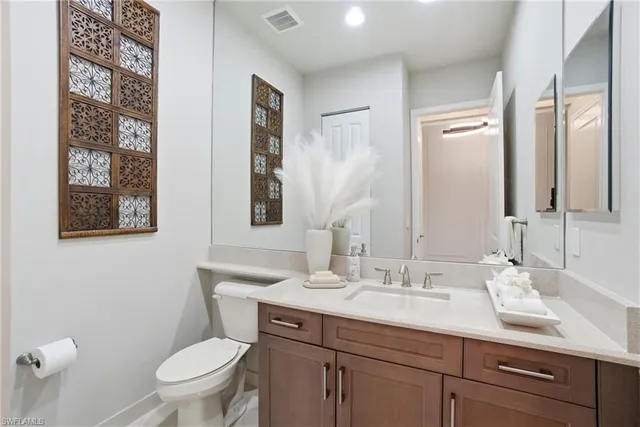 a bathroom with a toilet a sink a mirror and a shower