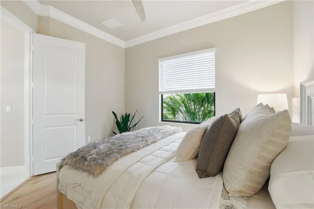 a bed sitting in a bedroom next to a window