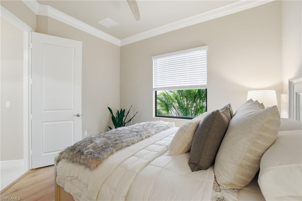 4318 Aurora Street Naples, FL 34119 - Photo 34 of 50 Bedroom featuring ornamental molding, wood finished floors, and a ceiling fan