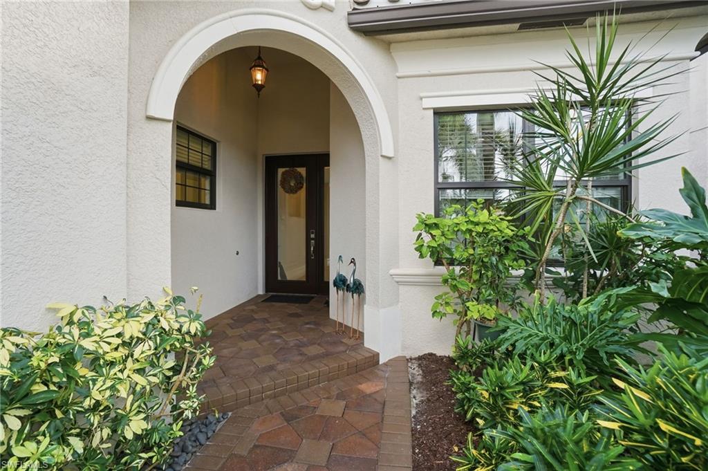 4318 Aurora Street Naples, FL 34119 - Photo 7 of 50 Inviting covered front entry framed by tropical landscaping