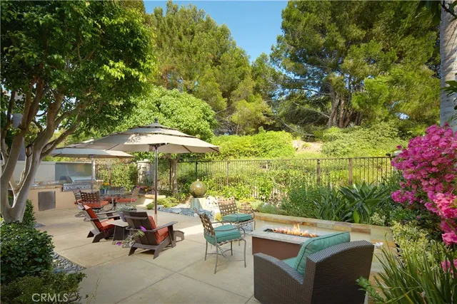 a view of a patio with table and chairs under an umbrella