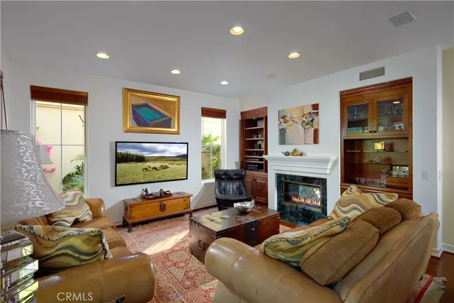 a living room with furniture flat screen tv and a fireplace