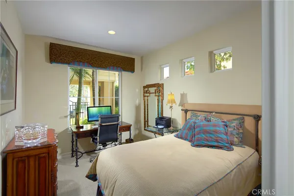 a bedroom with a bed and wooden table