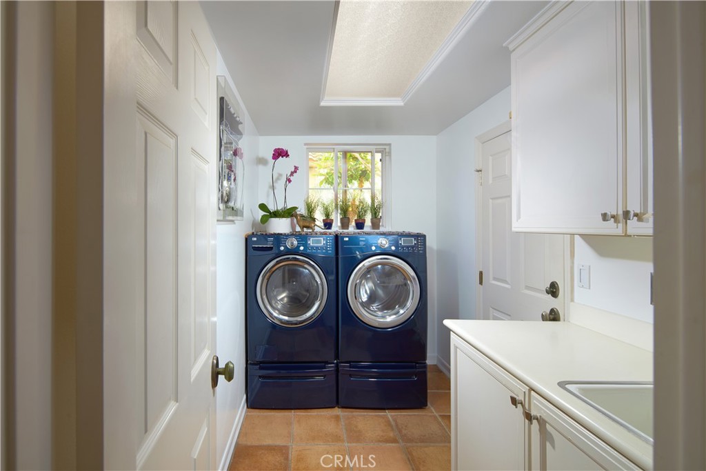 1432 Sea Ridge Drive Newport Beach, CA 92660 - Photo 16 of 25 a view of storage and utility room with washer and dryer
