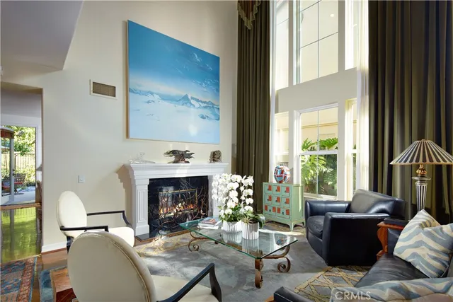 a living room with furniture fireplace and a large window