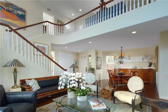 a living room with furniture kitchen view and a dining table