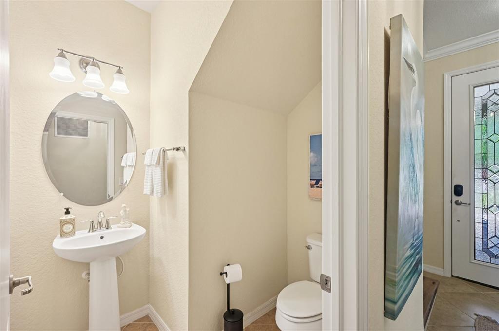 12680 Richezza Drive Venice, FL 34293 - Photo 14 of 57 a bathroom with a toilet sink and mirror