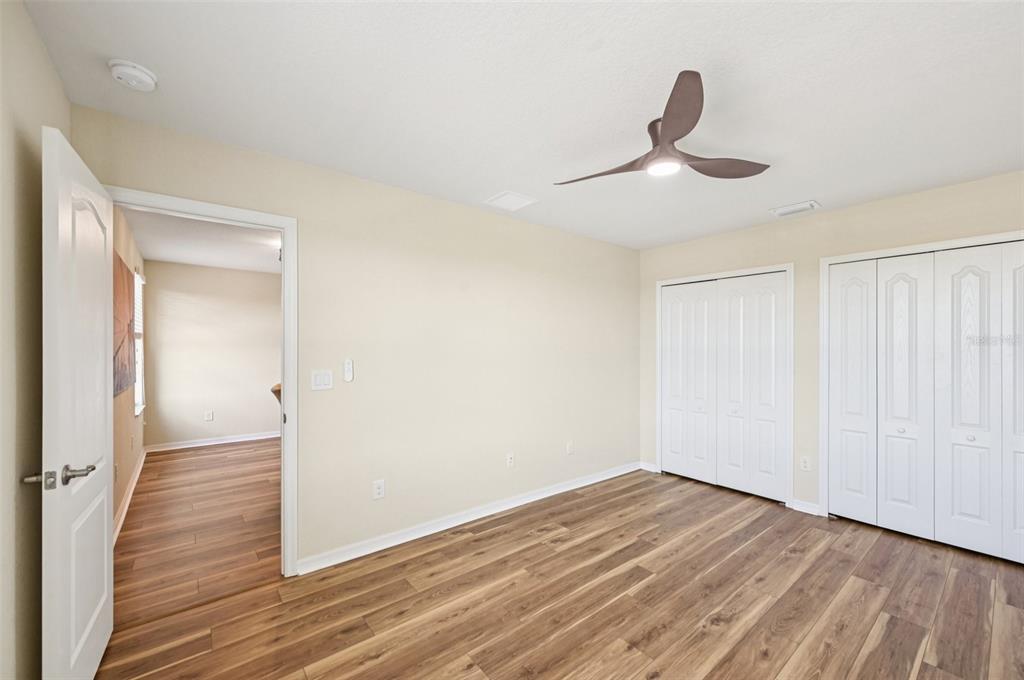 12680 Richezza Drive Venice, FL 34293 - Photo 18 of 57 a view of empty room with wooden floor