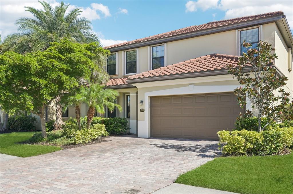 12680 Richezza Drive Venice, FL 34293 - Photo 2 of 57 a front view of a house with a yard and garage