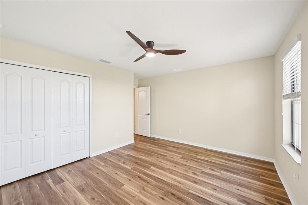 12680 Richezza Drive Venice, FL 34293 - Photo 21 of 57 wooden floor in an empty room with a window