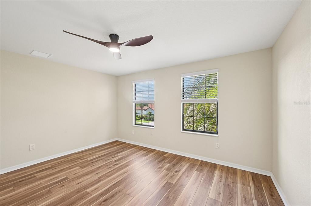 12680 Richezza Drive Venice, FL 34293 - Photo 22 of 57 a view of empty room with wooden floor and fan
