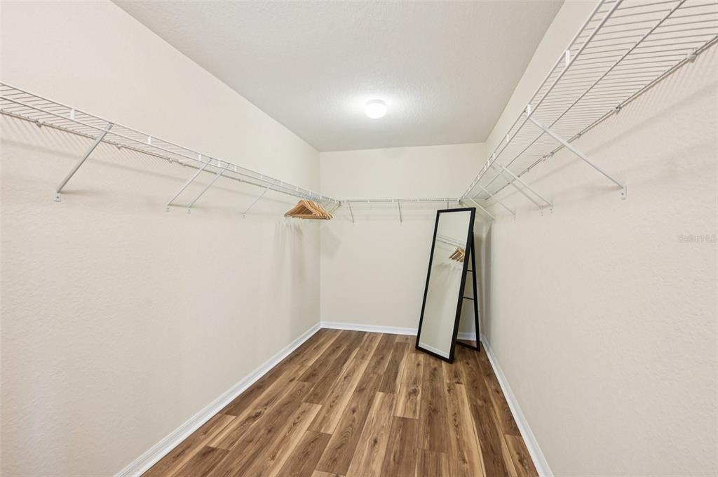 12680 Richezza Drive Venice, FL 34293 - Photo 30 of 57 a view of a room with wooden floor and white walls