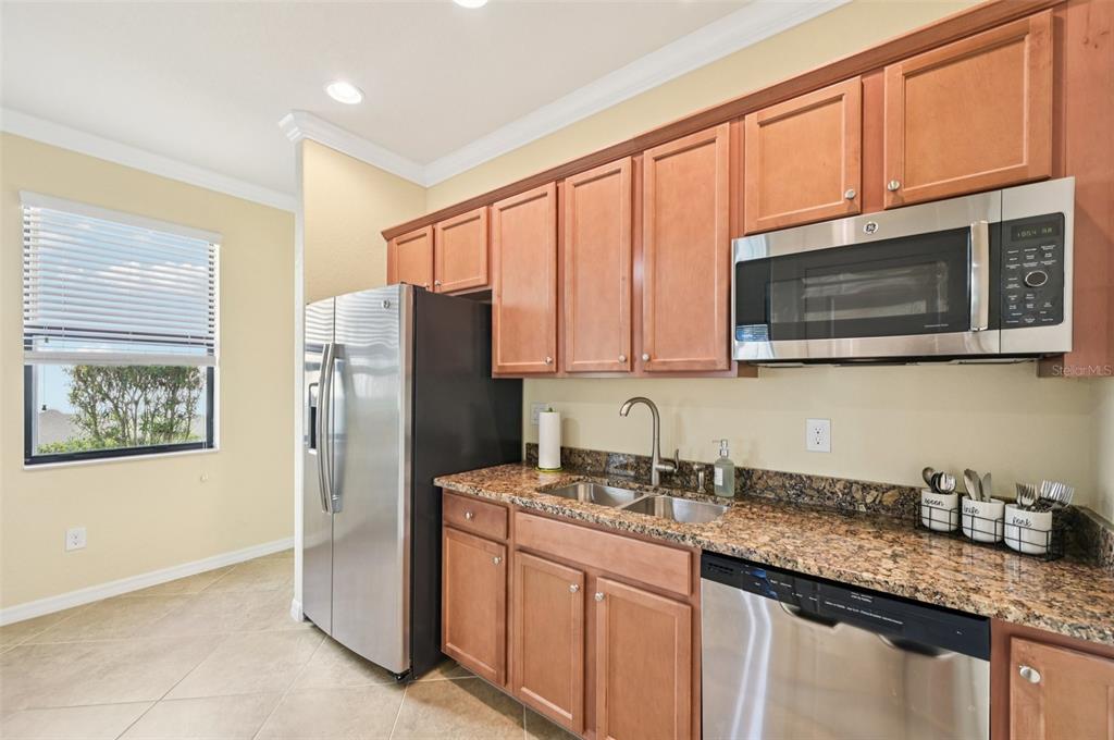 12680 Richezza Drive Venice, FL 34293 - Photo 40 of 57 a kitchen with stainless steel appliances granite countertop a refrigerator stove top oven and sink