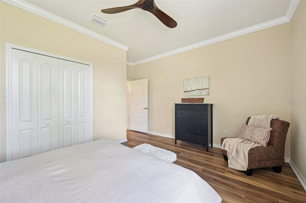 12680 Richezza Drive Venice, FL 34293 - Photo 44 of 57 a bedroom with a bed and dresser