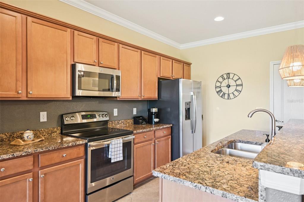 12680 Richezza Drive Venice, FL 34293 - Photo 9 of 57 a kitchen with stainless steel appliances granite countertop a stove a sink dishwasher and a refrigerator