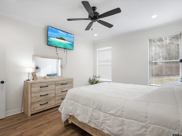 a bedroom with a bed dresser and a window