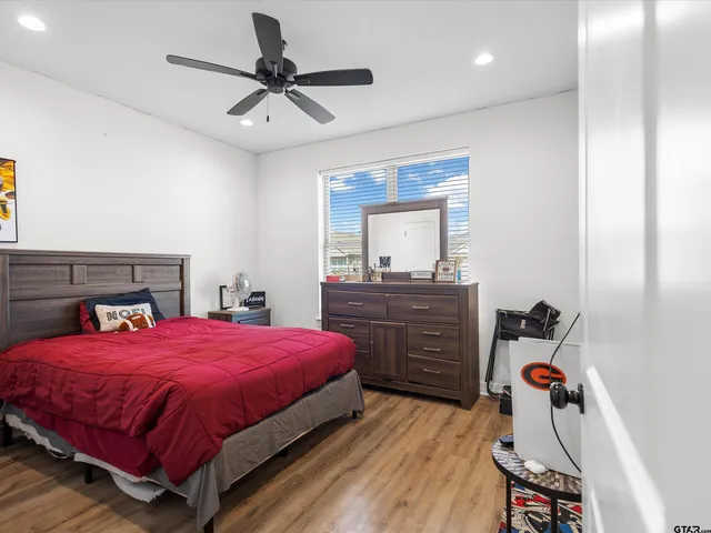 a bedroom with a bed and a dresser