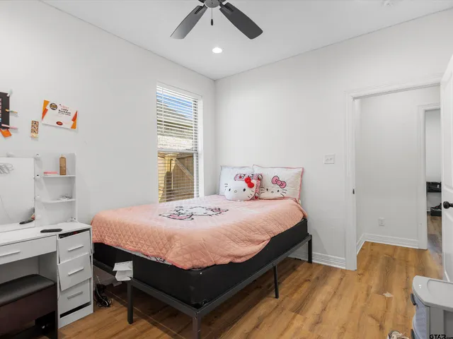 a bedroom with a bed and a table in it