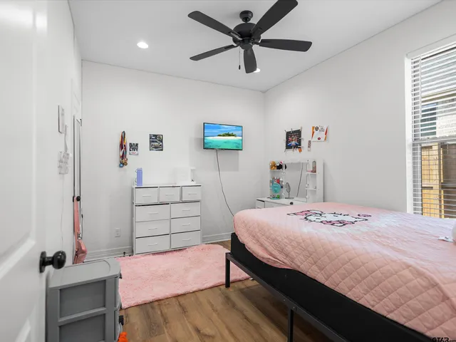 a bedroom that has a bed and a table in it