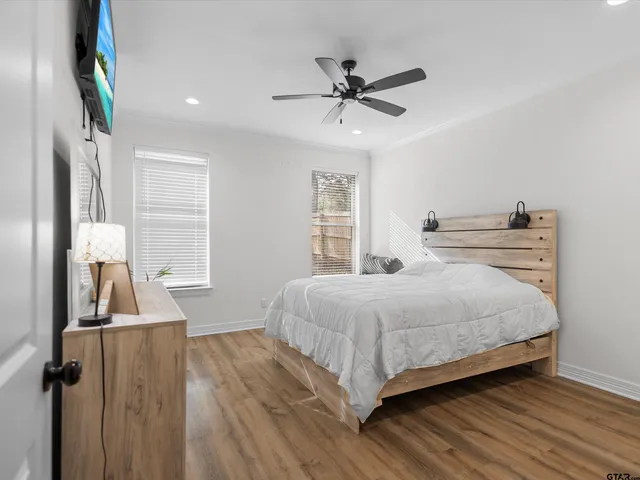 a bedroom with a bed and a chandelier