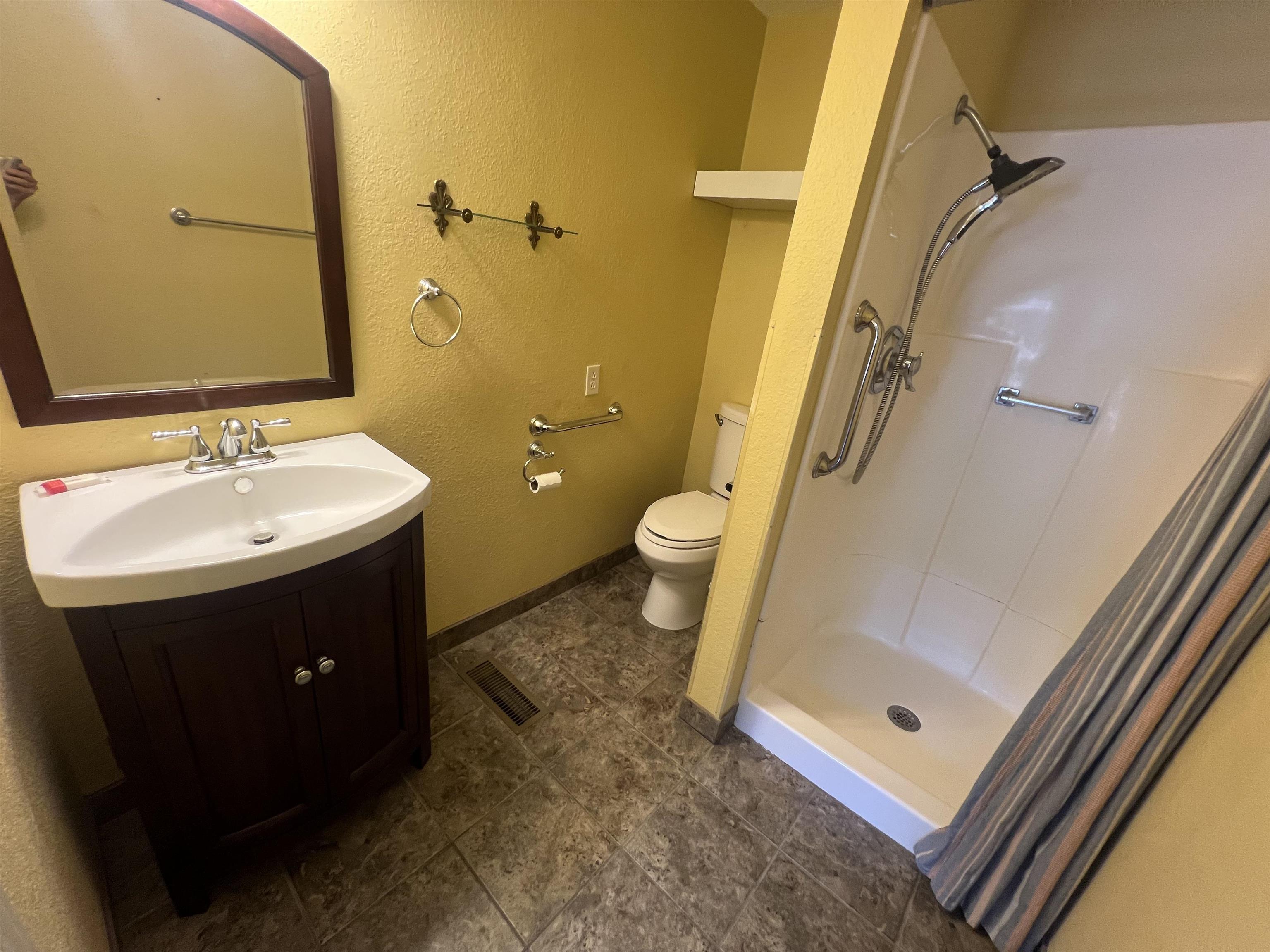300 Patterson Road Savannah, TN 38372 - Photo 11 of 30 a bathroom with a sink and mirror with toilet