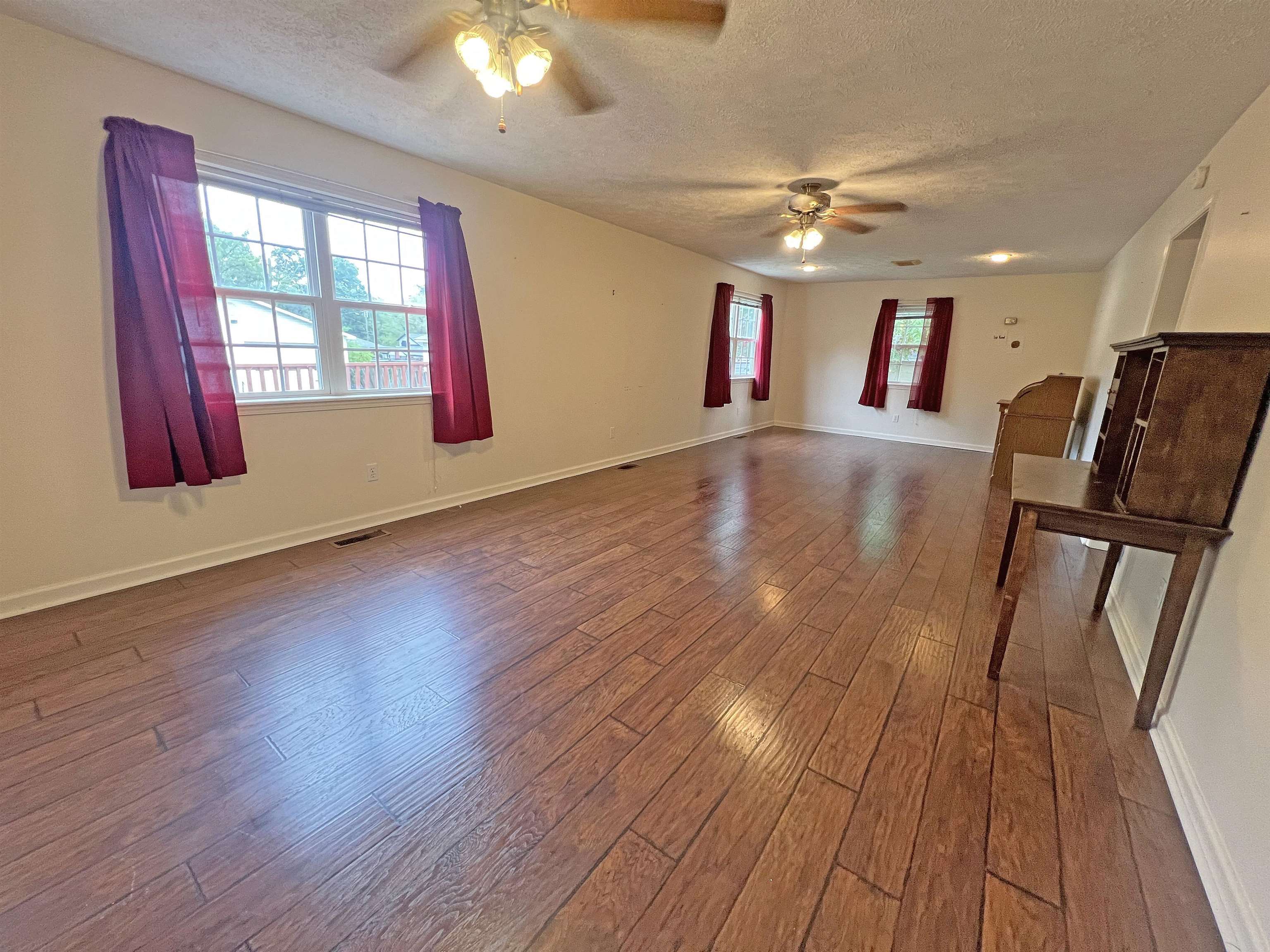 300 Patterson Road Savannah, TN 38372 - Photo 8 of 30 a view of a livingroom with furniture wooden floor and a ceiling fan