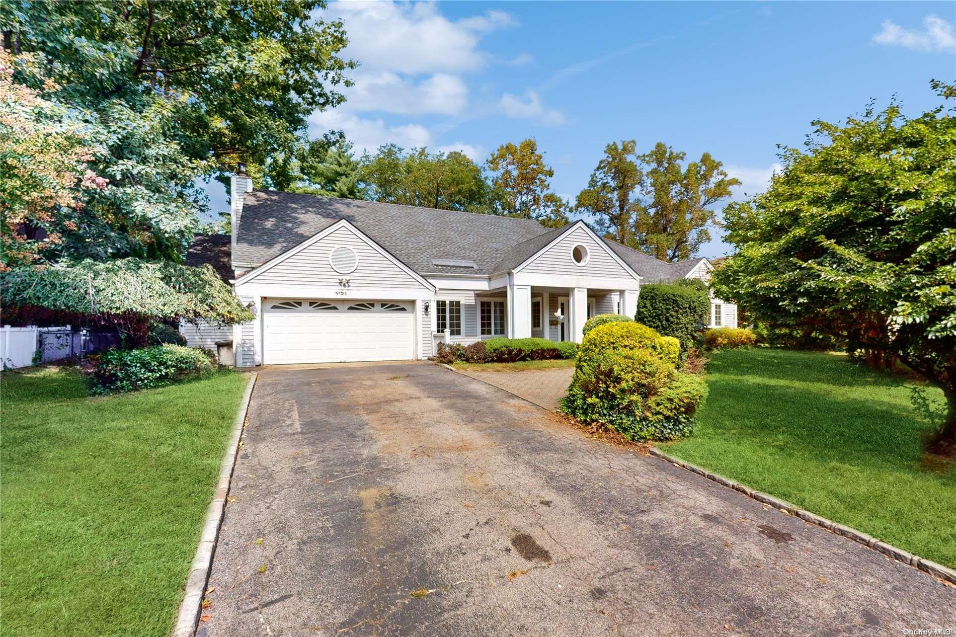 21 West Woods Road Lake Success, NY 11020 - Photo 1 of 1 a front view of a house with a garden