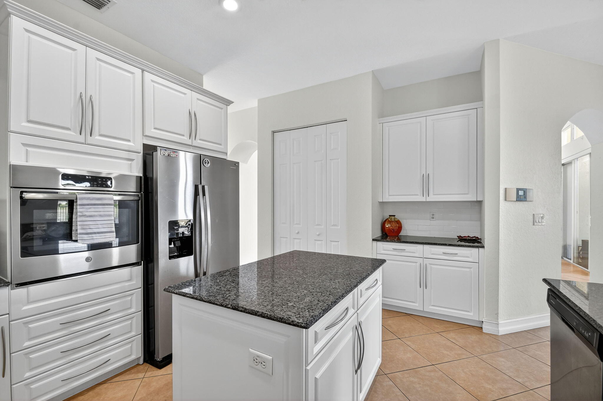 8797 Cobblestone Point Circle Boynton Beach, FL 33472 - Photo 13 of 67 a kitchen with stainless steel appliances granite countertop a refrigerator sink and cabinets