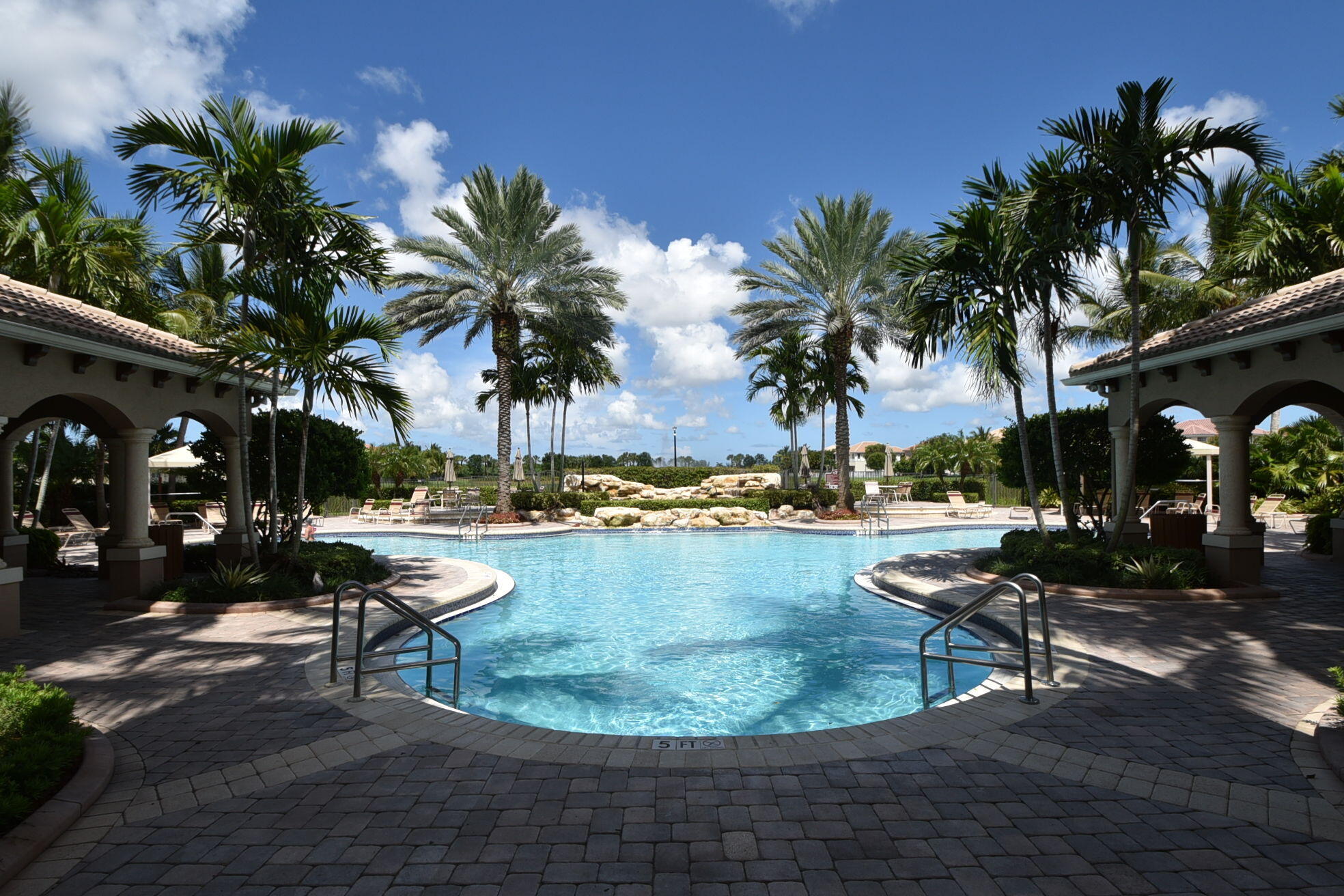 8797 Cobblestone Point Circle Boynton Beach, FL 33472 - Photo 62 of 67 a view of a swimming pool with lounge chairs