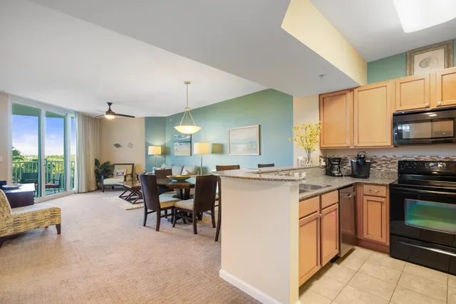 a kitchen with stainless steel appliances granite countertop a refrigerator sink and stove