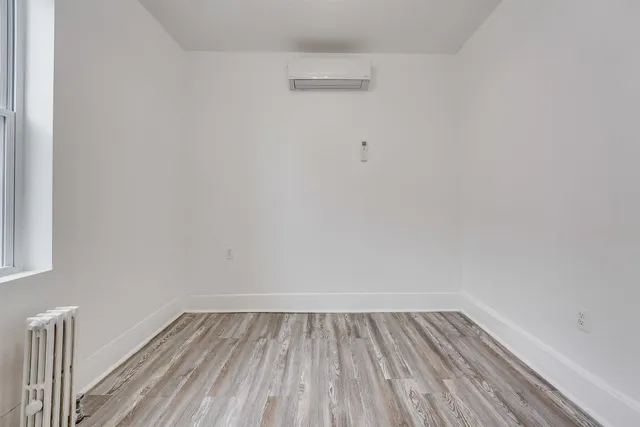 a view of a room with wooden floor