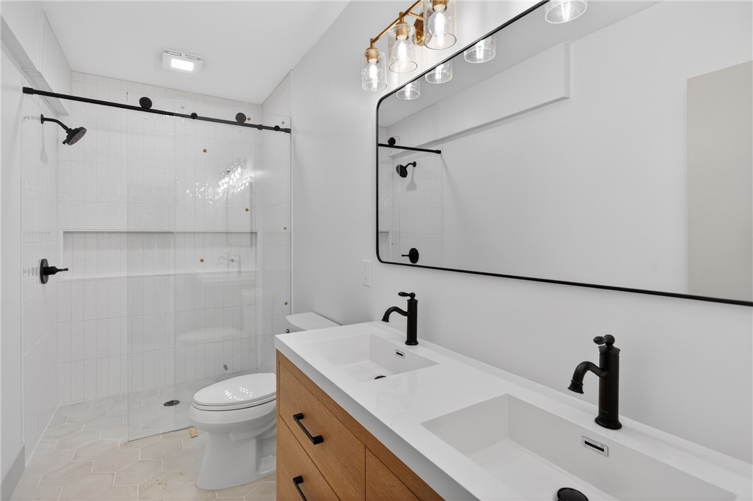 304 Lakeside Drive Seneca, SC 29672 - Photo 24 of 49 A well-appointed bathroom offers dual sinks, a spacious shower, and elegant fixtures.