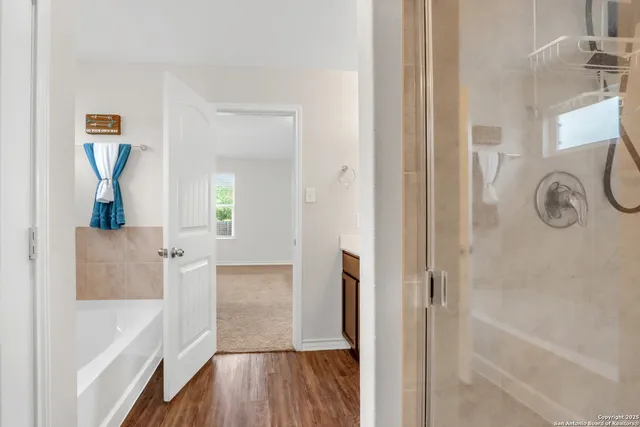 a bathroom with a bathtub and a shower