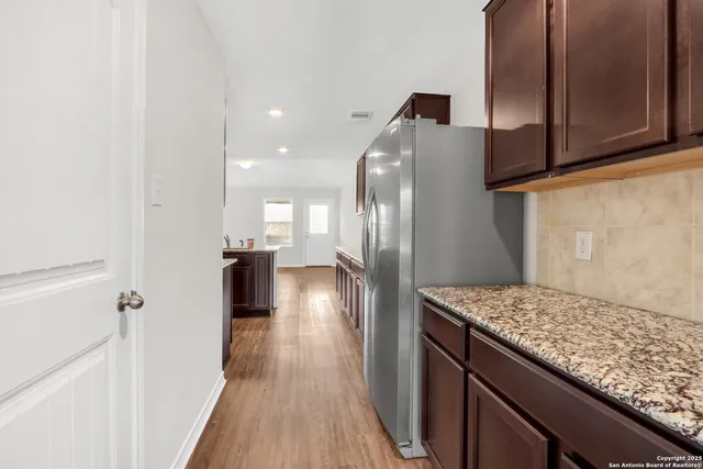 a view of a kitchen from the hallway