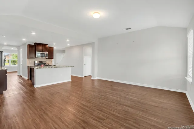 a view of kitchen with microwave and wooden floor