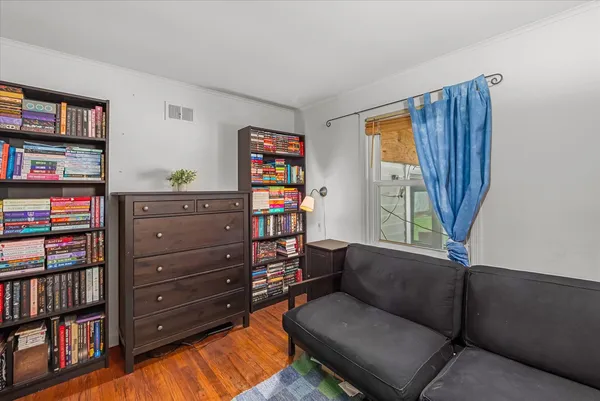 a living room with furniture and a book shelf