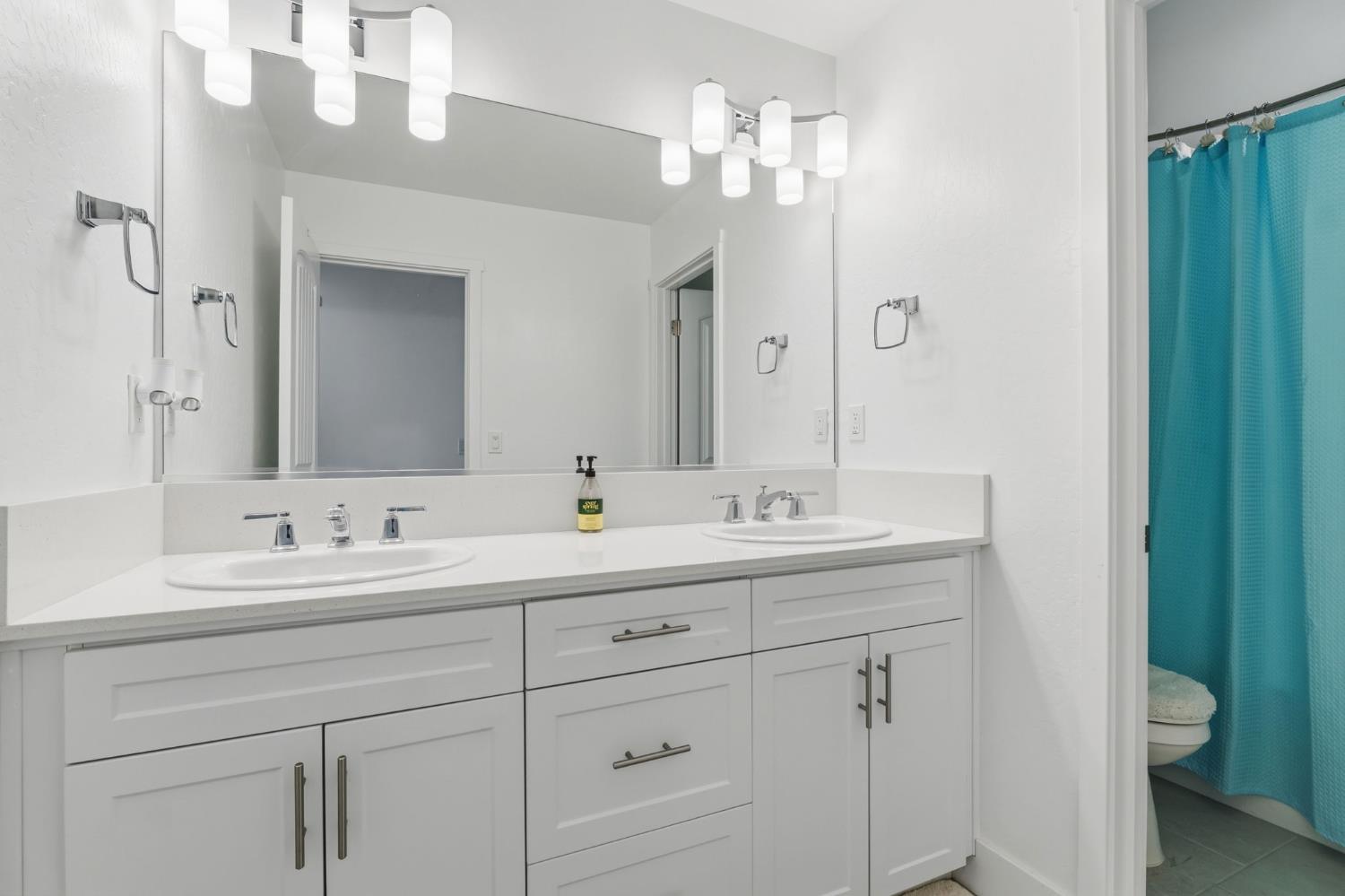 6326 West Richert Avenue Fresno, CA 93723 - Photo 32 of 45 a bathroom with a double vanity sink and a mirror