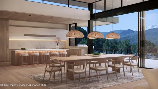 a kitchen with a table chairs and a wooden floor