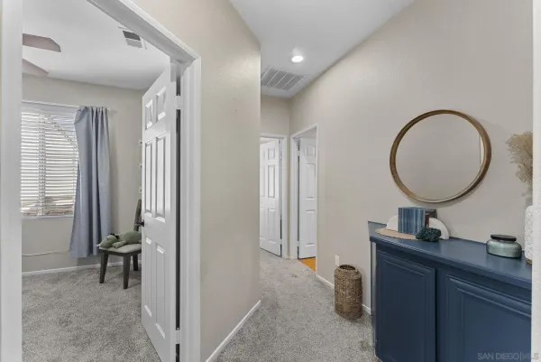 a living room with furniture and a mirror