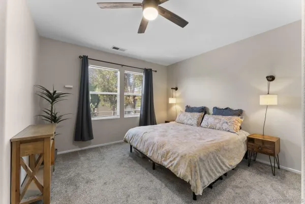 a bedroom with a large bed and a chandelier