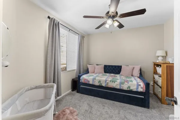 a bedroom with a bed and a couch