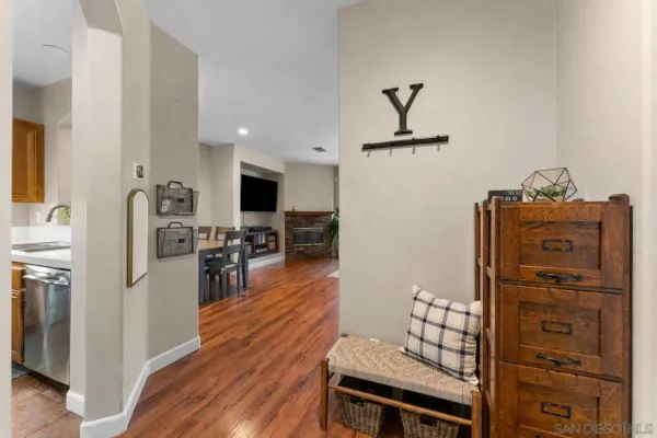 a living room with furniture wooden floor and a flat screen tv
