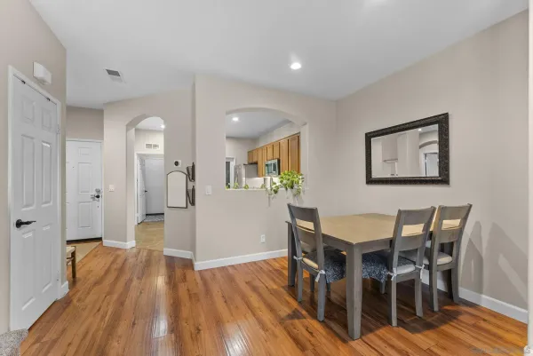 a view of a dining room with furniture and wooden floor
