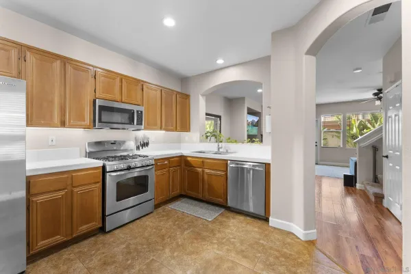 a kitchen with a sink stove and microwave