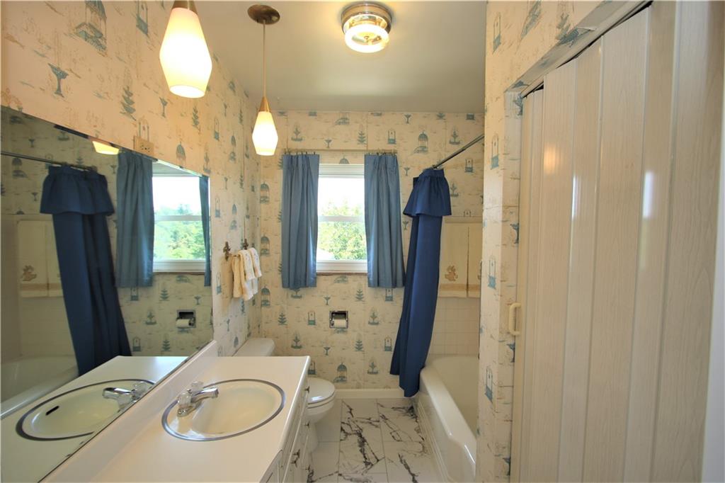 157 Taylor Run Road Monongahela, PA 15063 - Photo 15 of 42 Newer Flooring in Full Bathroom featuring Attractive Light Fixtures over extra-long Vanity PLUS Deep Shelved linen closet.