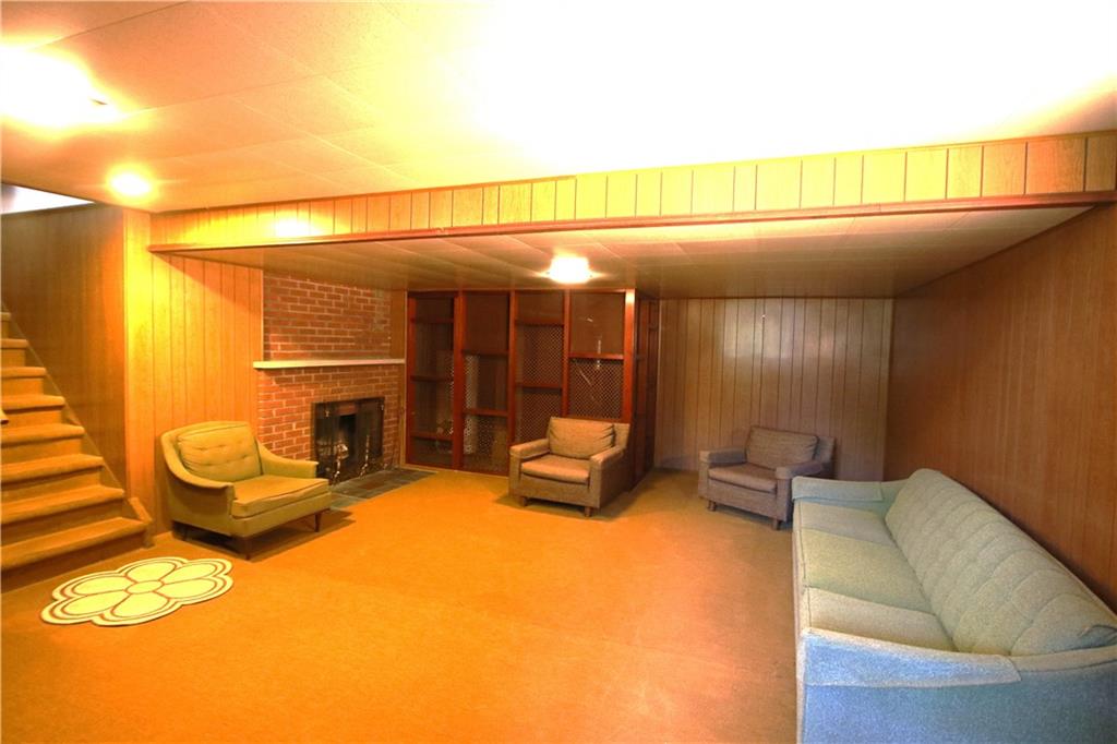 157 Taylor Run Road Monongahela, PA 15063 - Photo 19 of 42 MASSIVE 25x18 Family Room area w/ Wood Burning Fireplace. (Furnace installed Jan 2016 & Hot Water Tank nicely hidden behind Custom Designed Walls w/ Shelves, when viewing side door will be off for easy access to view)
