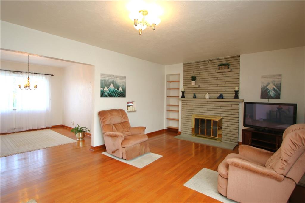 157 Taylor Run Road Monongahela, PA 15063 - Photo 2 of 42 Large 21x13 Living Room w/ Gorgeous Original Hardwood Floors, Brick Wood Burning Fireplace, Built-in Bookshelves, Attractive Light Fixture, Quality Plaster Walls & Marble Windowsills.